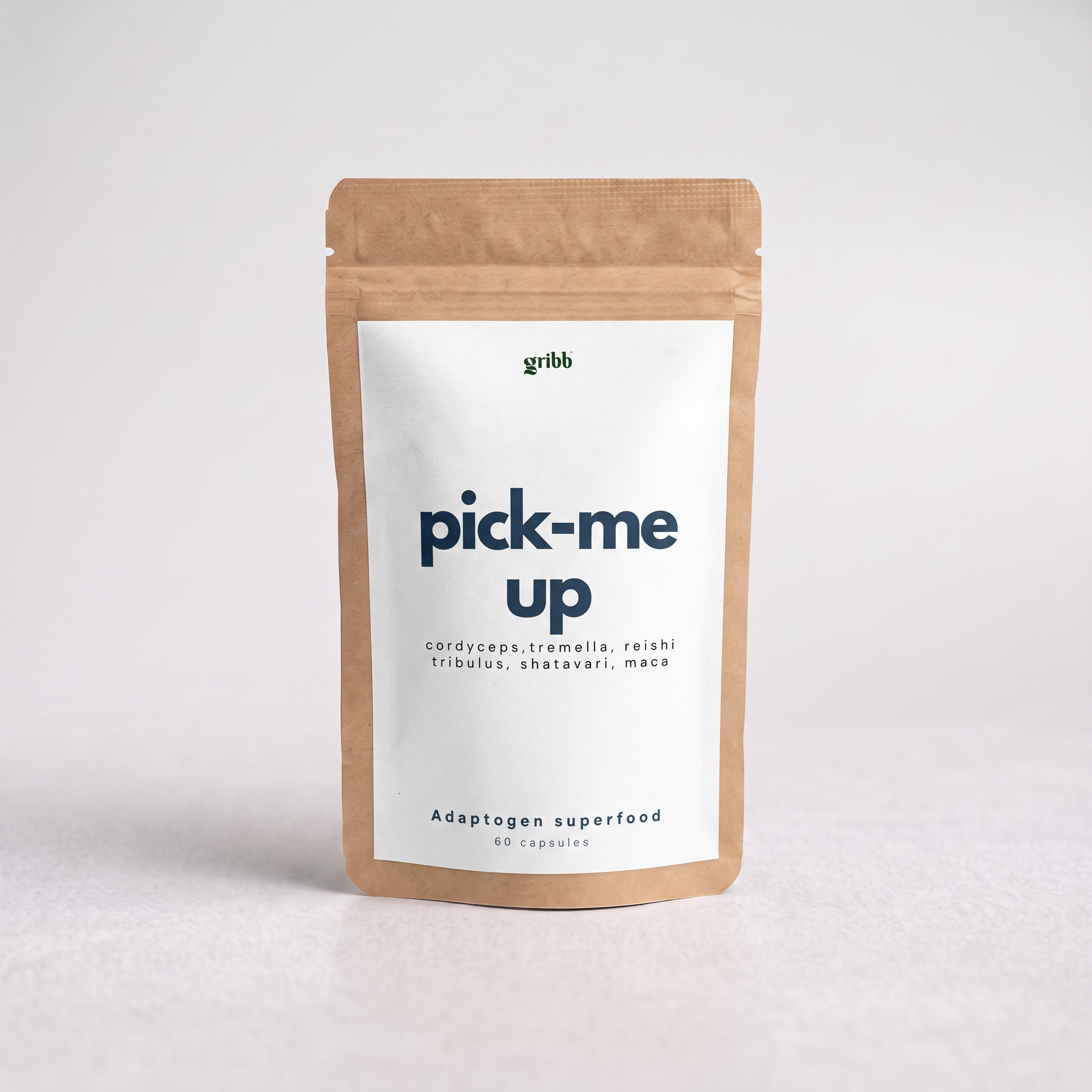 A kraft paper stand-up pouch with a white label reading 'pick-me up' and the brand name 'gribb' at the top, photographed on a light neutral background.