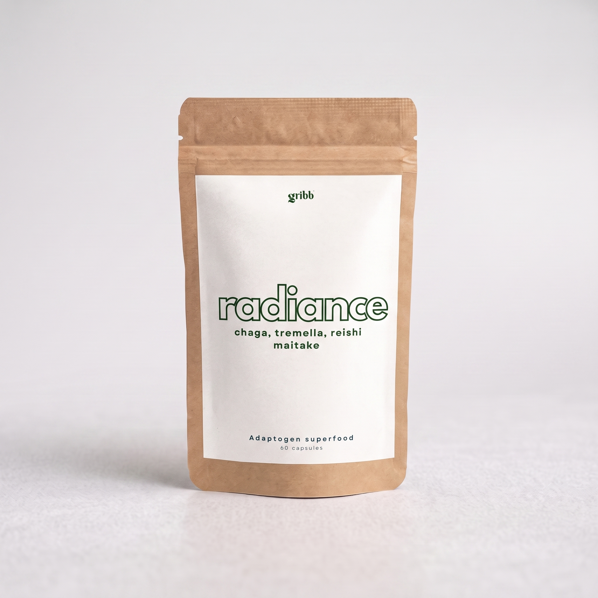 A kraft paper stand-up pouch with a white label reading 'radiance' and smaller text 'chaga, tremella, reishi maitake' on a light gray studio background.